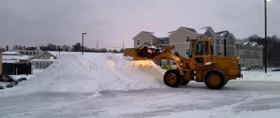 Our large plow moving snow in a parking lot at a apartment complex in Mayfield, KY. 