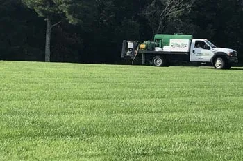 Our fertilizing truck applying fertilizer and weed control on a large lawn in Mayfield, KY..