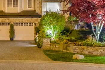 Landscape lighting that includes uplighting of a tree at a home in Mayfield, KY.