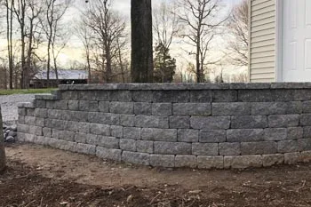 New retaining wall installed to help with erosion for a driveway at a residential property in Benton, KY.